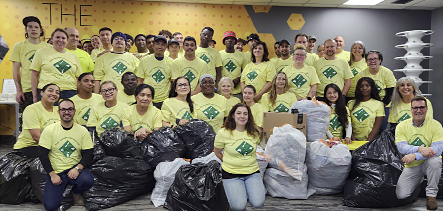 Group photo of Profile employees with donated clothing